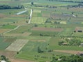 panorama seen from above of the plain with the cultivated fields divided into geometric shapes in spring Royalty Free Stock Photo