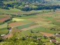 panorama seen from above of plain with the cultivated fields divided into shapes