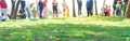 Panorama selective focus long line of diverse kids with parents after brightly colored barricade tape and multicolor Royalty Free Stock Photo