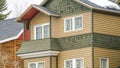 Panorama Selective focus of townhome with balcony and snowy roof against cloudy sky