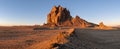 Panorama of the Shiprock rock formation rising above a vast landscape in dramatic early morning light Royalty Free Stock Photo