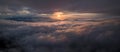 Panorama shot of colorful light of sunrise over rainforest mountains with fog and cloud inversion for natural cinematic of Royalty Free Stock Photo