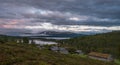 Panorama shot of old abandoned farm houses lakes, mountains and dramatic skies in the norwegian mountains.