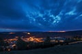 panorama over the city of laaber at the blue hour with brightly lit city and street lighting