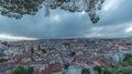 Panorama showing aerial cityscape day to night transition from Miradouro da Graca viewing point in Lisbon city after