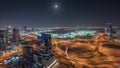 Panorama showing Dubai marina and JLT skyscrapers along Sheikh Zayed Road aerial night .