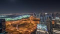 Panorama showing Dubai marina and JLT skyscrapers along Sheikh Zayed Road aerial night timelapse.