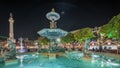 Panorama showing illuminated fountain with holiday decorations at the Rossio Christmas Market timelapse on Dom Pedro IV Royalty Free Stock Photo