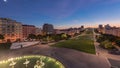 Panorama showing lawn at Alameda Dom Afonso Henriques and the Luminous Fountain aerial day to night timelapse in Lisbon. Royalty Free Stock Photo