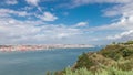 Panorama showing Lisbon cityscape and Tagus river timelapse with 25 of April bridge Royalty Free Stock Photo