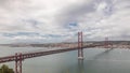 Panorama showing Lisbon cityscape and Tagus river timelapse with 25 of April bridge Royalty Free Stock Photo