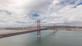 Panorama showing Lisbon cityscape and Tagus river timelapse with 25 of April bridge Royalty Free Stock Photo