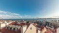 Panorama showing red roofs timelapse and 25 de Abril Bridge, Iconic suspension bridge over Tagus River in Lisbon Royalty Free Stock Photo