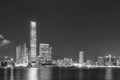 Panorama of skyline of Victoria harbor of Hong Kong city at night in monochrome Royalty Free Stock Photo