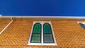 Panorama Sliding arched glas windows of a church in provo Utah against brick wall