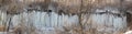 Panorama of the slope of the ravine, along which streamlets of water ran and froze in the frost, forming an icy wall of icicles re