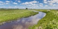 Panorama of a small river going through the flat dutch landscape in Groningen Royalty Free Stock Photo
