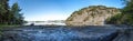 Panorama of a small rocky beach of Gandsfjord fjord near Dale with a tourist setting a campfire