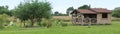 Panorama with a small summer lodge and a garden Royalty Free Stock Photo