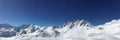 Panorama of snowy mountain peaks and ski slopes at Tignes, ski resort in the Alps France Royalty Free Stock Photo