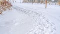 Panorama Snowy trail along Oquirrh Lake with view of a clubhouse and arched bridge