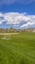 Panorama Soccer field and baseball field with view of mountain and cloudy blue sky