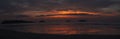 Panorama of spectacular sunset on beach with bright colors and no people on palm tree Koh Chang Island, Thailand