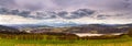 Panorama of spring snowy Tatra mountains. Lake and village behind high mountain range Royalty Free Stock Photo