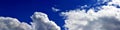 Panorama of spring, summer clouds on a blue sunny sky, background, texture. Royalty Free Stock Photo