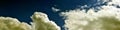 Panorama of spring, summer clouds on a blue sunny sky, background, texture. Royalty Free Stock Photo