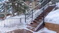 Panorama Stairs and wooden deck on snowy hill with decorative and colorful string lights Royalty Free Stock Photo