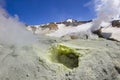 Steaming crater of active volcano covered by snow