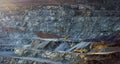 Panorama of stepped wall of diabase quarry with two stone crushing machines