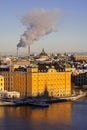 Panorama of Stockholm city with chimneys on a sunny winter day photographed from the hill. Royalty Free Stock Photo