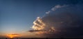 Storm clouds panoramic vista with setting sun