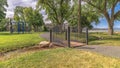 Panorama Sunny day view at a park with kids playground and bridge over a shallow creek Royalty Free Stock Photo