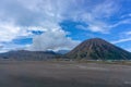 Panorama sunrise view of Mount Bromo, still active volcano and part of the Tengger massif with mist and cloud from vocalno crater. Royalty Free Stock Photo
