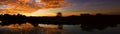 Panorama sunset beautiful colorful landscape and silhouette tree mountain river reflect in sky twilight time Royalty Free Stock Photo