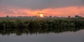 Panorama of sunset over fields of polder and Kromme Ie canal in Friesland, Netherlands