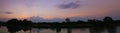 Panorama sunset in sky beautiful colorful landscape silhouette tree woodland and river reflect the twilight time Royalty Free Stock Photo