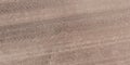 Panorama of surface from above of gravel road with car tire tracks Royalty Free Stock Photo