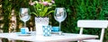 Panorama table setting with a wine glasses, cups and flowers in a pot Royalty Free Stock Photo