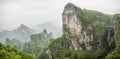 Panorama of the Tianmen Mountain Peak with a view of the cave Known as The Heaven`s Gate surrounded by the green forest and mist Royalty Free Stock Photo