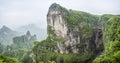 Panorama of the Tianmen Mountain Peak with a view of the cave Known as The Heaven`s Gate surrounded by the green forest and mist