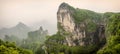 Panorama of the Tianmen Mountain Peak with a view of the cave Known as The Heaven`s Gate surrounded by the green forest and mist