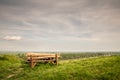 Panorama of Titelski breg, or titel hill, in Vojvodina, Serbia, with a wooden bench, a table, green trees & the river tisa (or