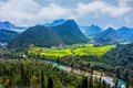 The Panorama Top view Yellow Flowers of Rapeseed fields with stream Jiulong Waterfalls and mountain in background at Luoping, Royalty Free Stock Photo