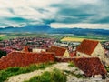 Panorama of the town on the background of tiled roofs of ancient buildings in the Rasnov castle in Romania. Beautiful landscape of