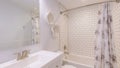 Panorama Traditional bathroom with white floral theme and tub shower with subway tiles surround