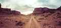 Panorama of a two track dirt road heading into the sunset of Canyonlands National Park Royalty Free Stock Photo